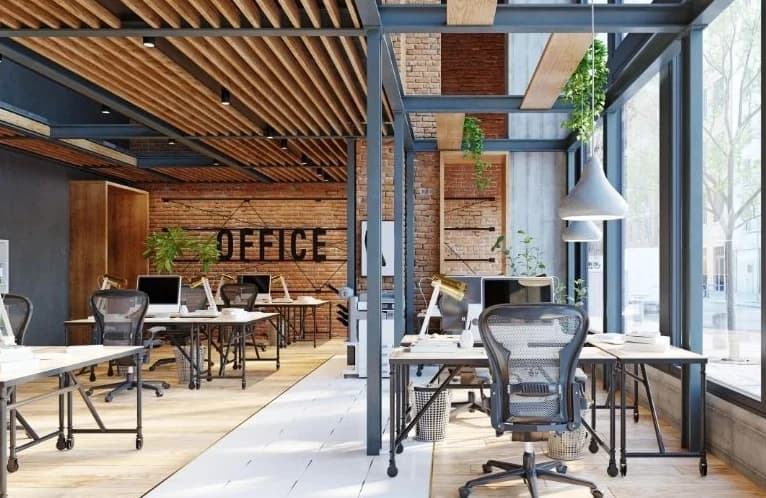 Illustrative open-plan startup workspace with desks and computer displays